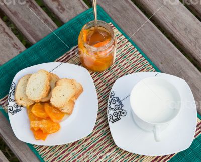 Homemade tangerine marmalade on the small square dessert plate