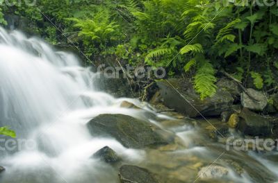 landscape with waterfall in the mountains 