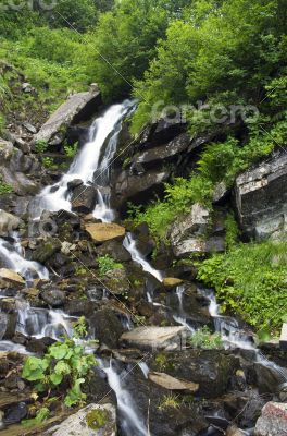 landscape with waterfall in the mountains 