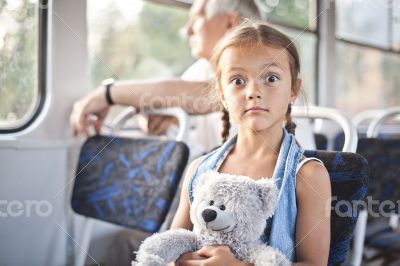 Funny open eyed girl in a tram