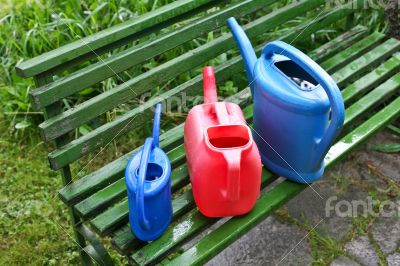 Watering cans in garden