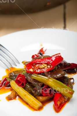 fried chili pepper and vegetable on a wok pan