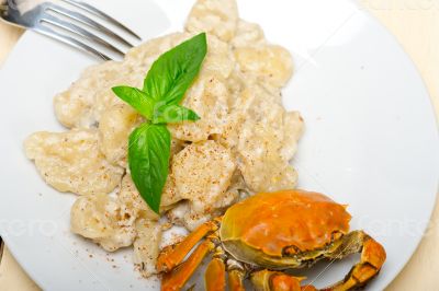 Italian gnocchi with seafood sauce with crab and basil