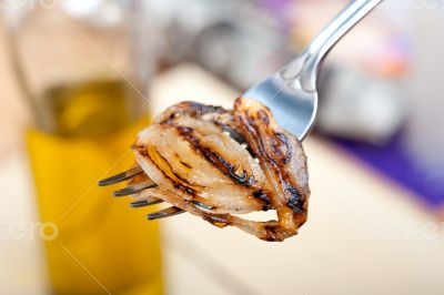 grilled onion on a fork
