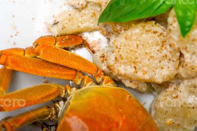 Italian gnocchi with seafood sauce with crab and basil