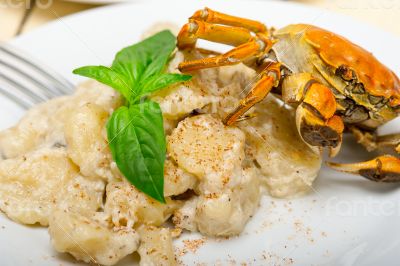 Italian gnocchi with seafood sauce with crab and basil