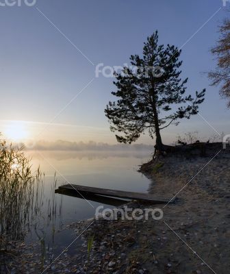 Foggy morning landscape in the autumn park near the lake. Vintag
