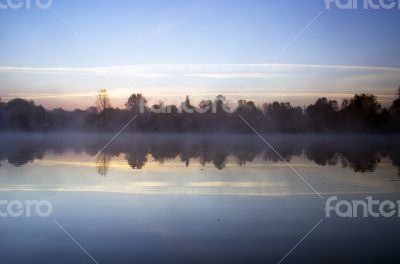 Foggy morning landscape in the autumn park near the lake. Vintag