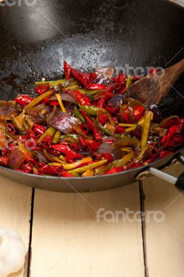 fried chili pepper and vegetable on a wok pan