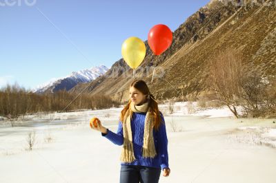 Funny girl with oranges and balloons on the hair 