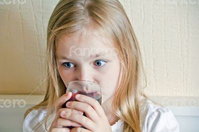 Cute girl drinking beverage