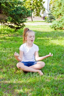Cute girl in lotus pose