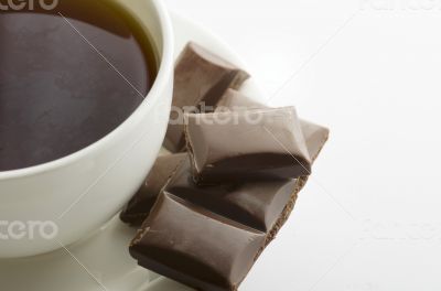 Cup of hot tea with dark chocolate