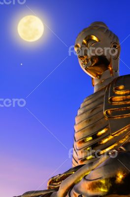 Buddha statue under the full moon 