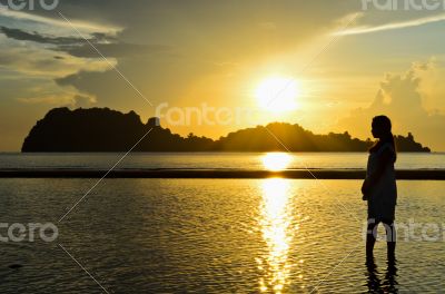 Girls on the beach during sunrise.