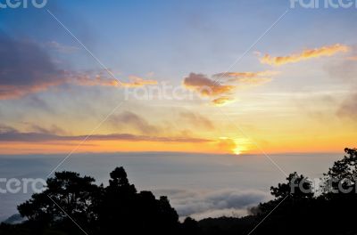 Colorful sunrise above the clouds