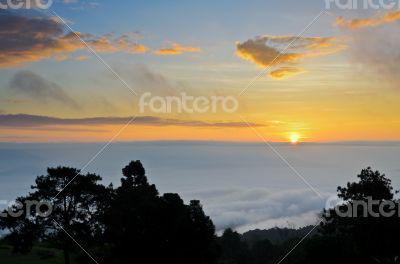 Colorful sunrise above the clouds