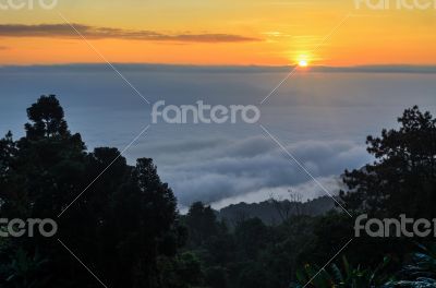 Colorful sunrise above the clouds