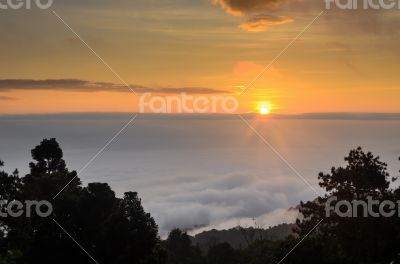 Colorful sunrise above the clouds