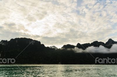 Sunrise over the mountains and green lake