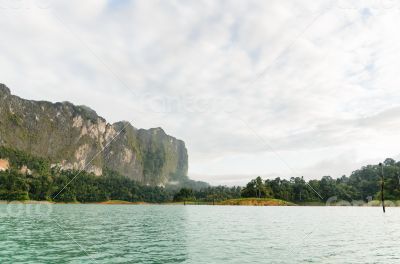 Sky above the mountains and green lake
