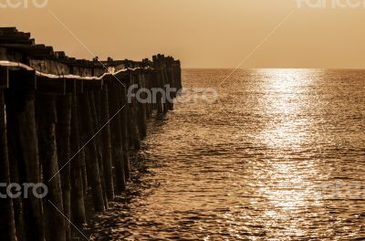 Old wooden bridge at sunrise with sepia
