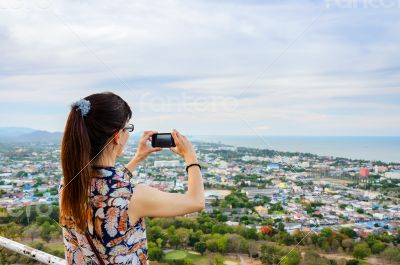 Woman using phone taking pictures