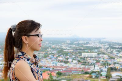 Women look at a view of the city from on high.