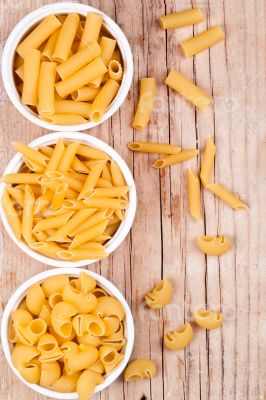 uncooked pasta in three bowls