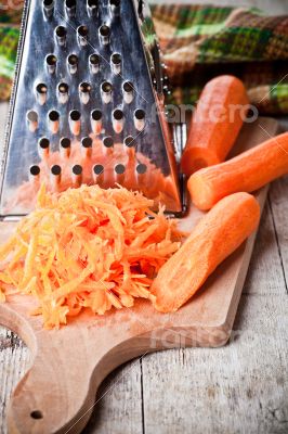 metal grater and carrots