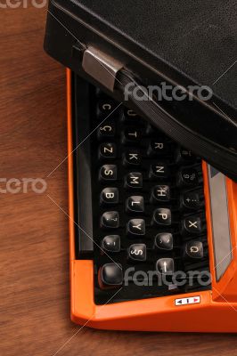 The Orange Vintage Typewriter on the Wood