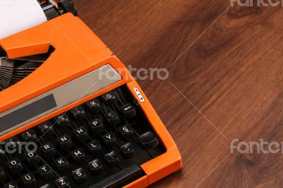 The Orange Vintage Typewriter on the Wood
