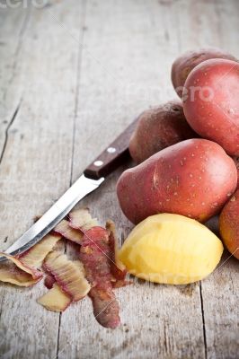  peeled potatoes and knife