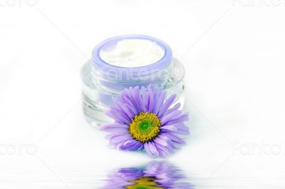 Closeup of open container of cosmetic face cream 