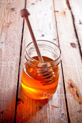 full honey pot and honey stick 