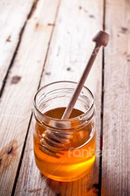 full honey pot and honey stick 