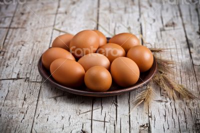  fresh brown eggs in plate
