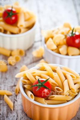 uncooked pasta and cherry tomatoes