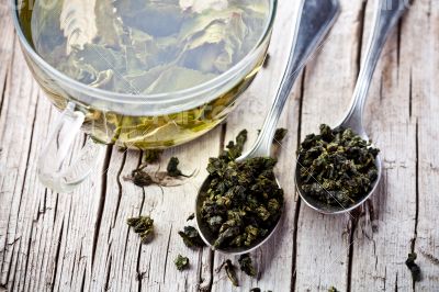 cup of green tea and spoons 