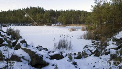 Panorama of an abandoned stone pit in winter 