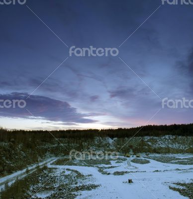 Panorama of an abandoned stone pit in winter 