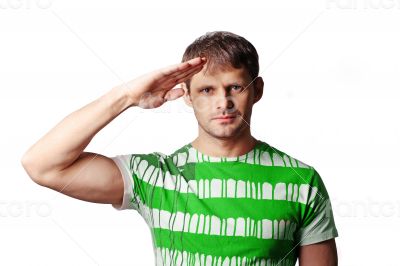 Saluting young man over a white background