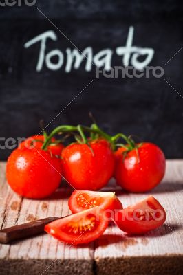 fresh tomatoes, knife and blackboard 