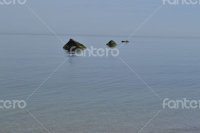 Fisherman between rocks