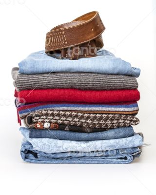 Pile of woolen jumpers of various colors and textures