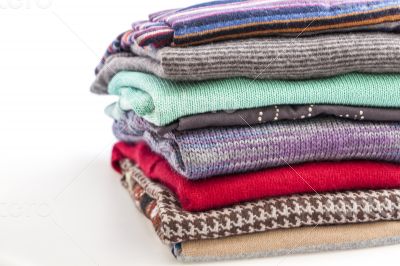 Pile of woolen jumpers of various colors and textures