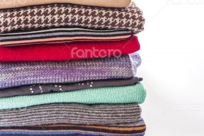 Pile of woolen jumpers of various colors and textures