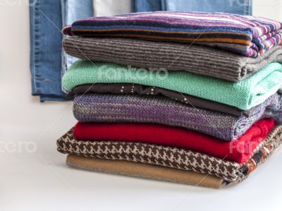 Pile of woolen jumpers of various colors and textures