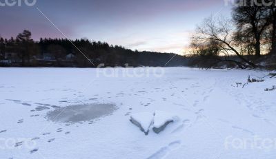 clear river ice in cold winter morning under sunbeams