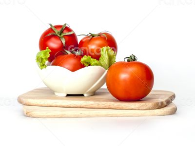 Red juicy tomatoes and lettuce leaves
